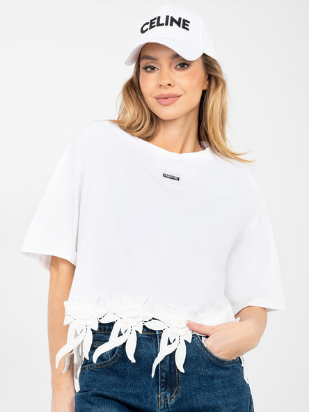 Weiße Oversize-Bluse mit Blumenapplikation.
