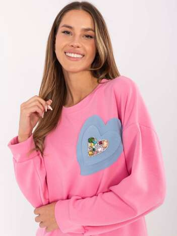 Hurt Pink sweatshirt with a heart-shaped patch.