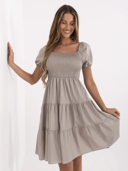 Dark beige flared dress with a ruffle.