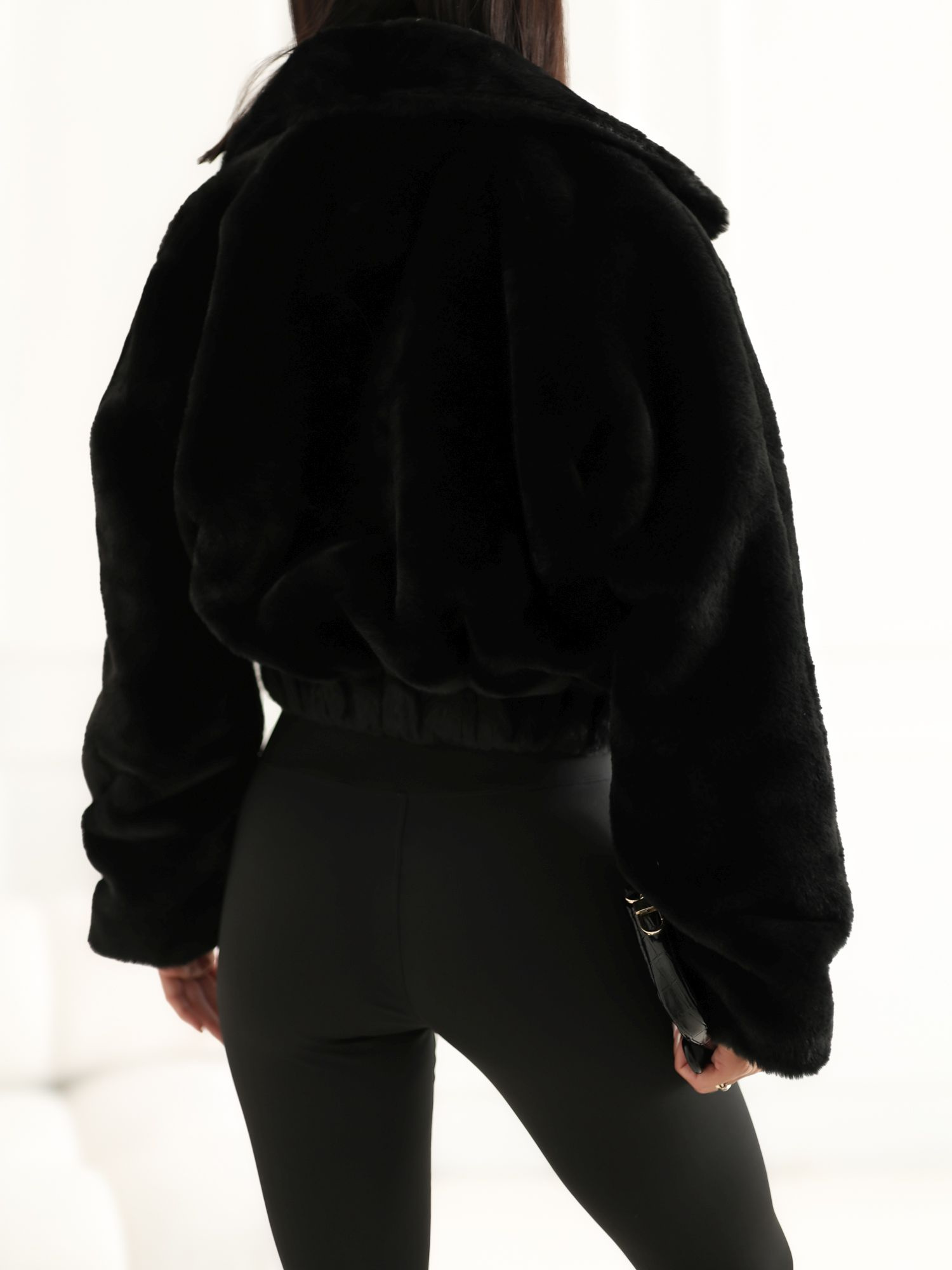 Black short fur jacket with a collar.