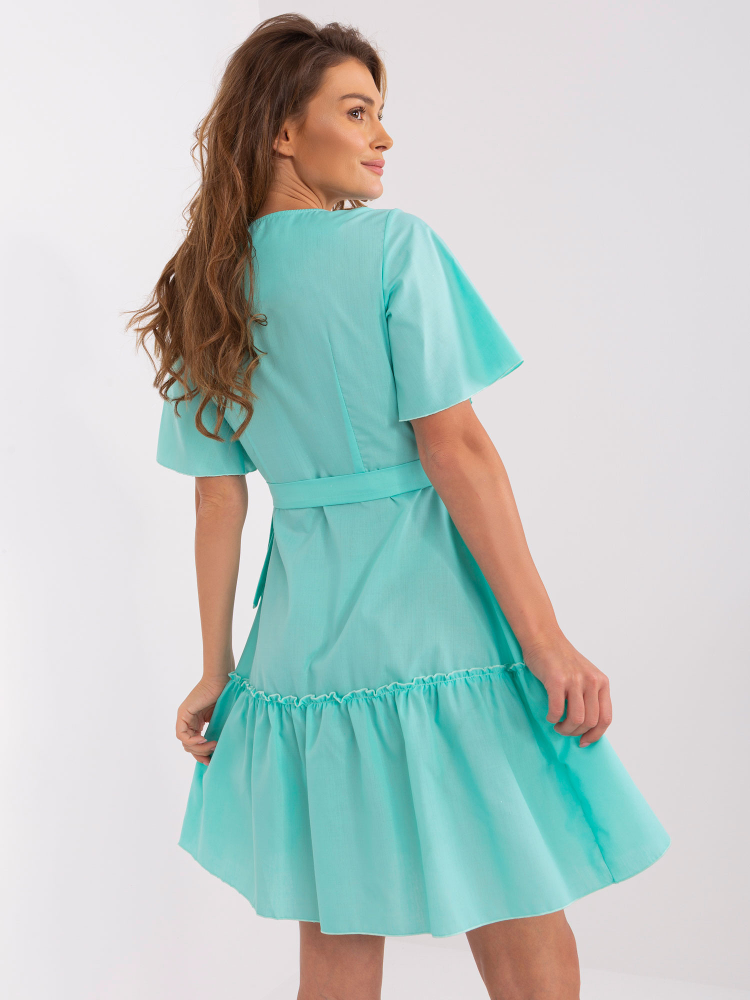 Mint green envelope dress with ruffle.
