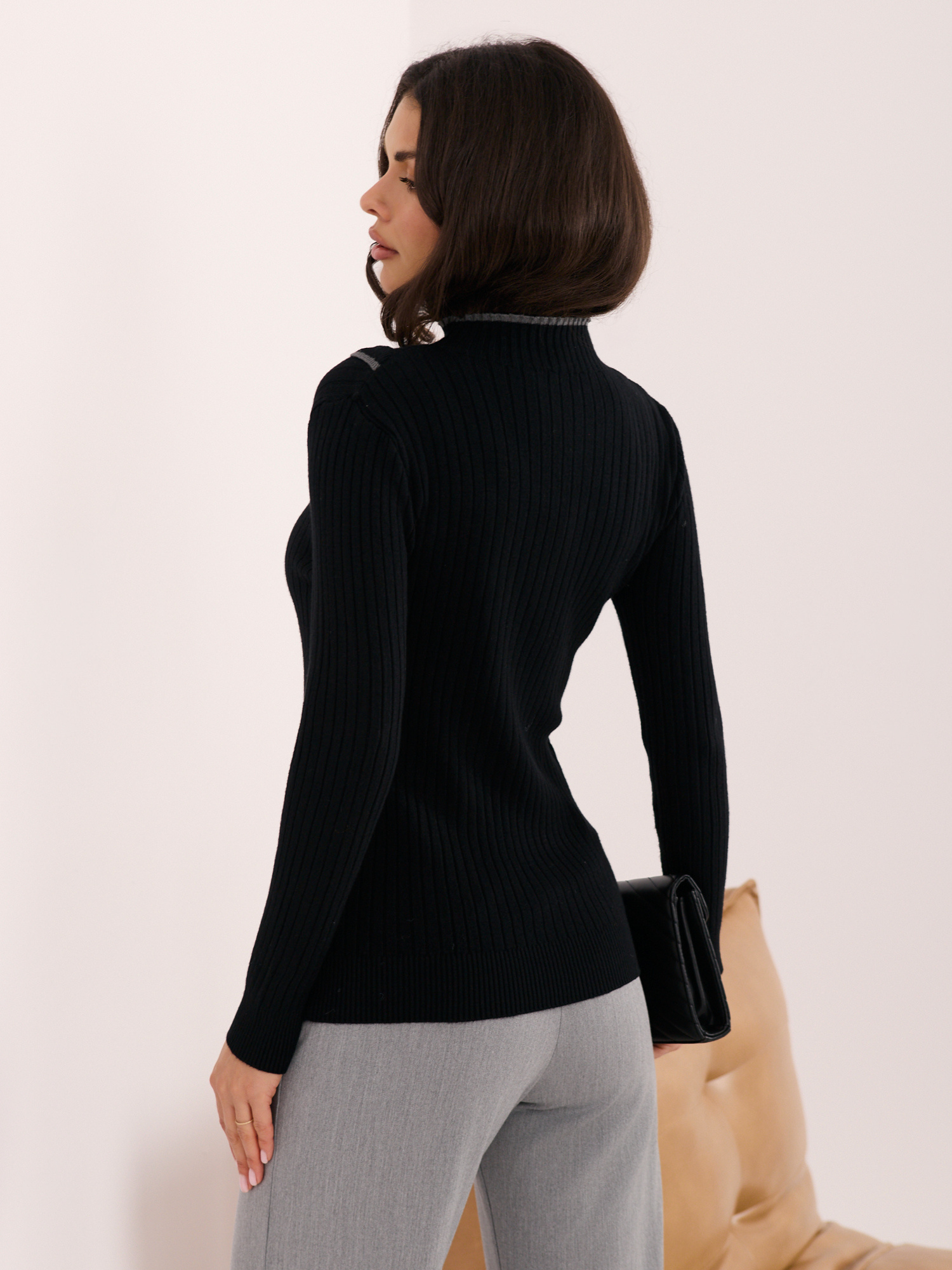 Black ribbed sweater with a mock turtleneck.