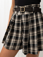 Black skirt-shorts with a woven belt.