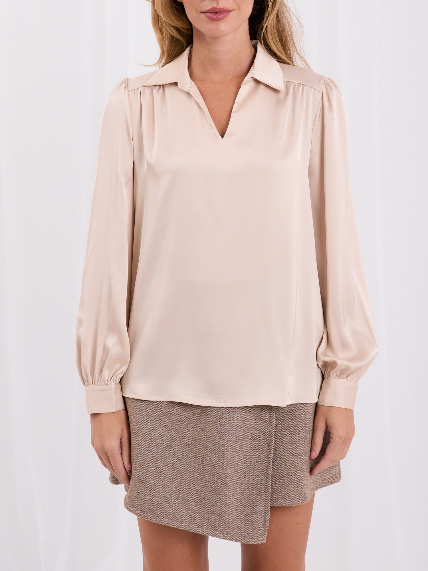 Light beige elegant blouse with a satin effect.