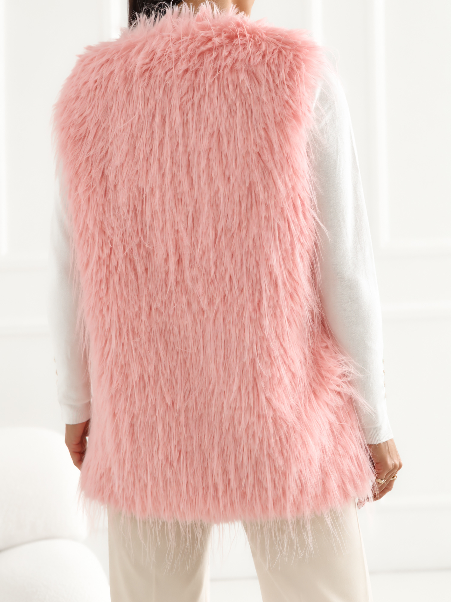 "Light pink fur vest with pockets."