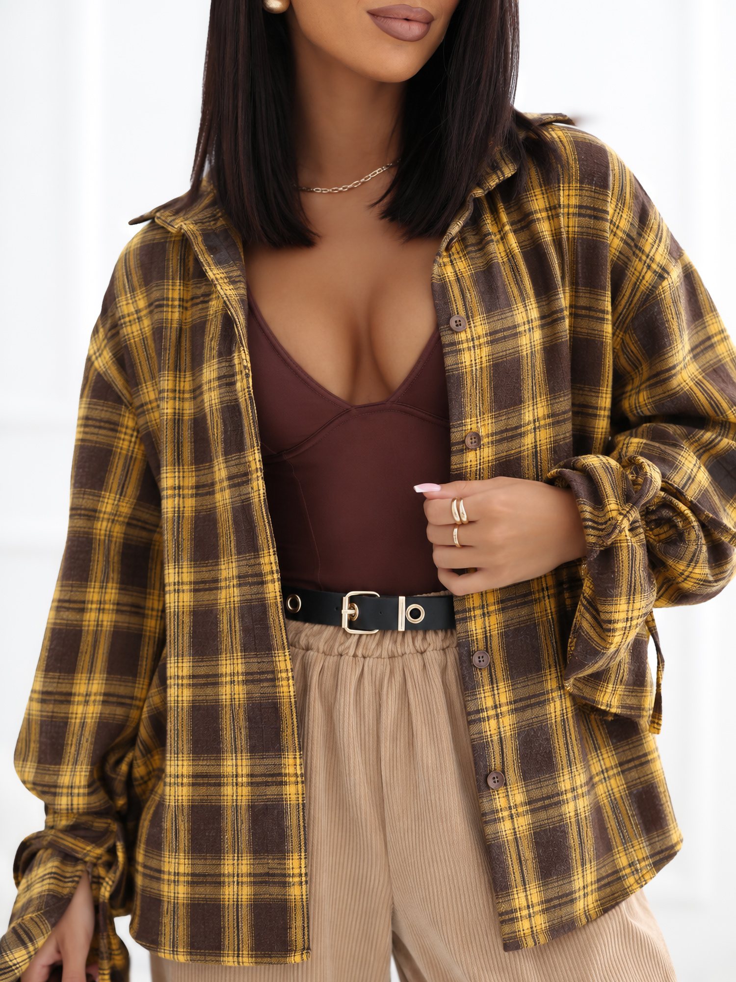 Yellow checkered shirt with decorative ties at the cuffs.