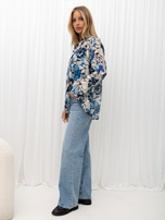 Blue button-up shirt with painted flowers.