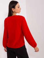 Hurt red blouse with a round neckline.