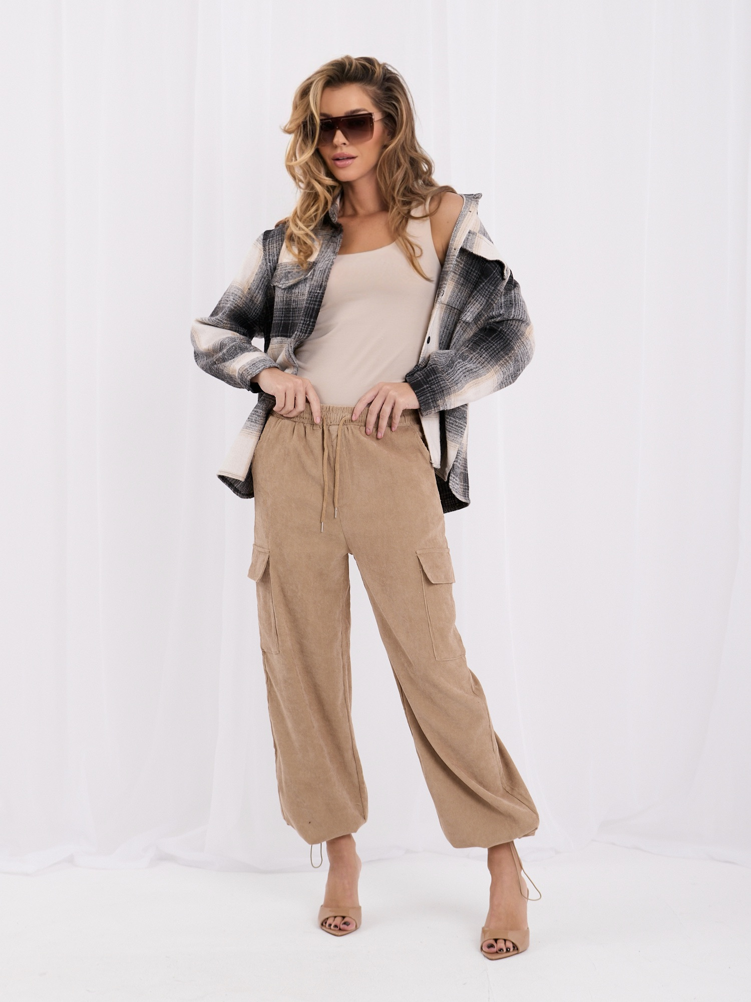 Camel corduroy cargo pants with a waist tie.