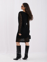Black cocktail dress made of gathered mesh.