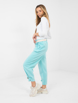 Miętowe dresowe spodnie z kieszeniami 