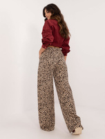 Hurtownia Beżowo-czarne długie spodnie w panterkę