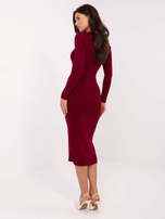 Burgundy knitted dress with decorative buttons.