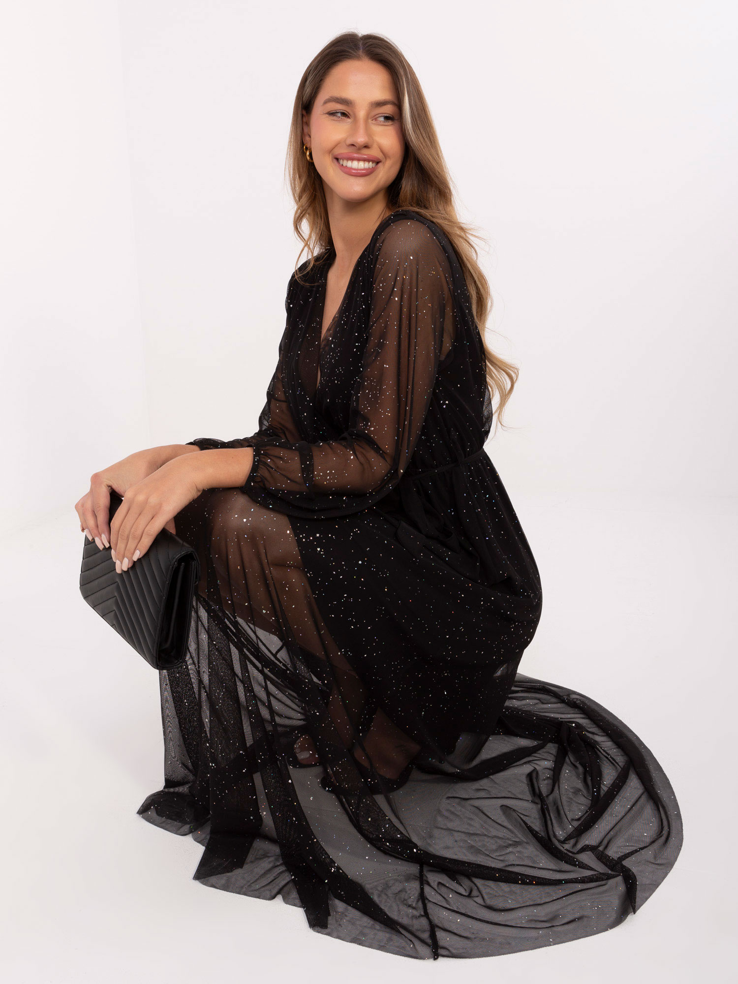 Black evening dress with a tied belt.