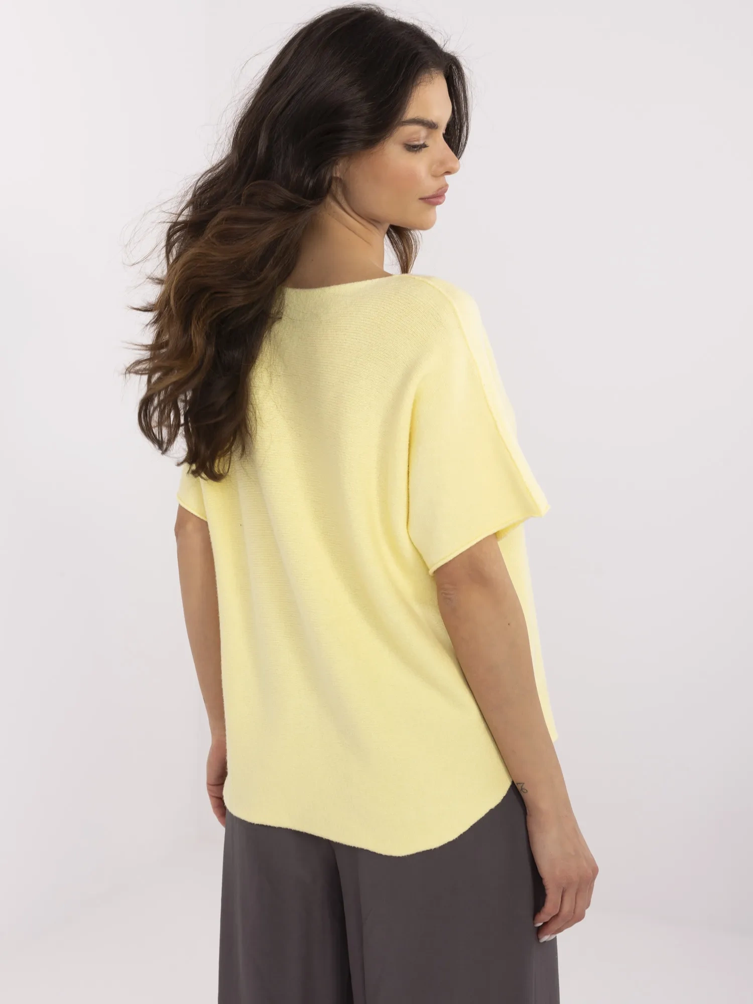 Light yellow reversible sweater with a V-neck.