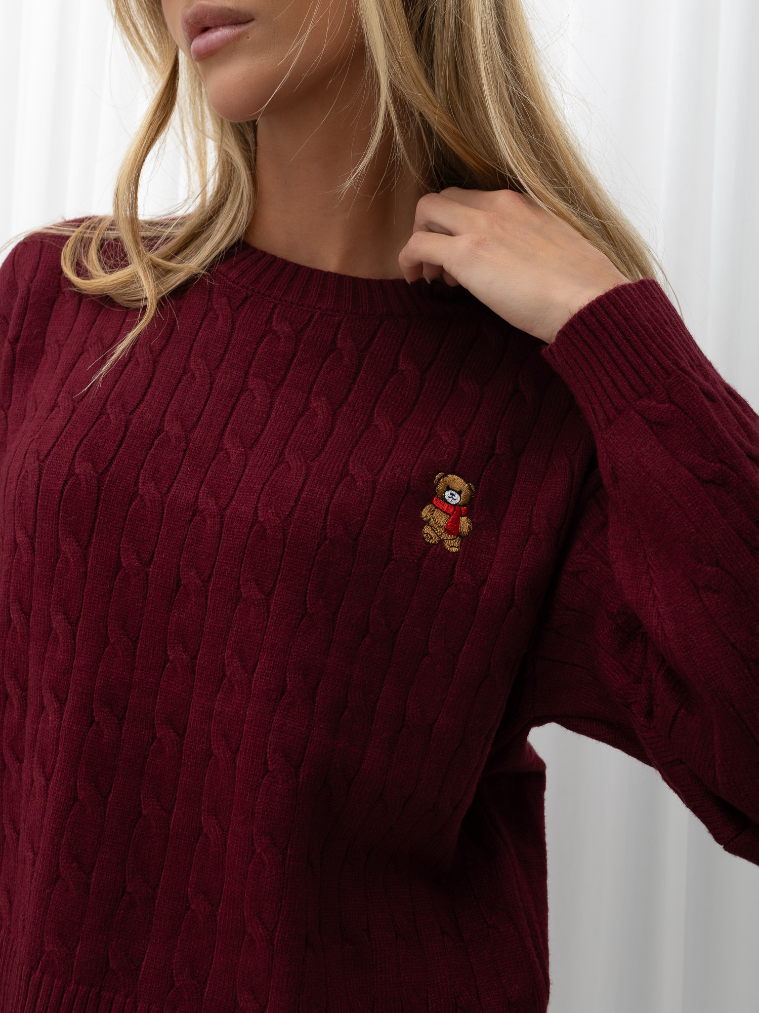 Burgundy short sweater with a cable knit.