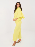 Jasnożółte damskie jeansy z ozdobnymi pomponami