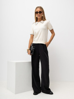 Light beige women's polo sweater with buttons at the neckline.