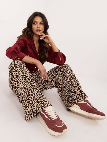 Hurtownia Beżowo-czarne długie spodnie w panterkę