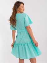 Mint green envelope dress with ruffle.