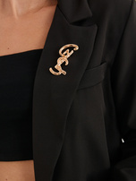 Black single-breasted blazer with a brooch.