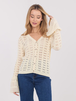 Light beige sweater with bell sleeves.
