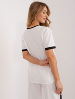 Wholesale Ecru women's blouse with decorative buttons.