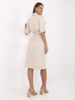 Beige shirt dress with a belt.