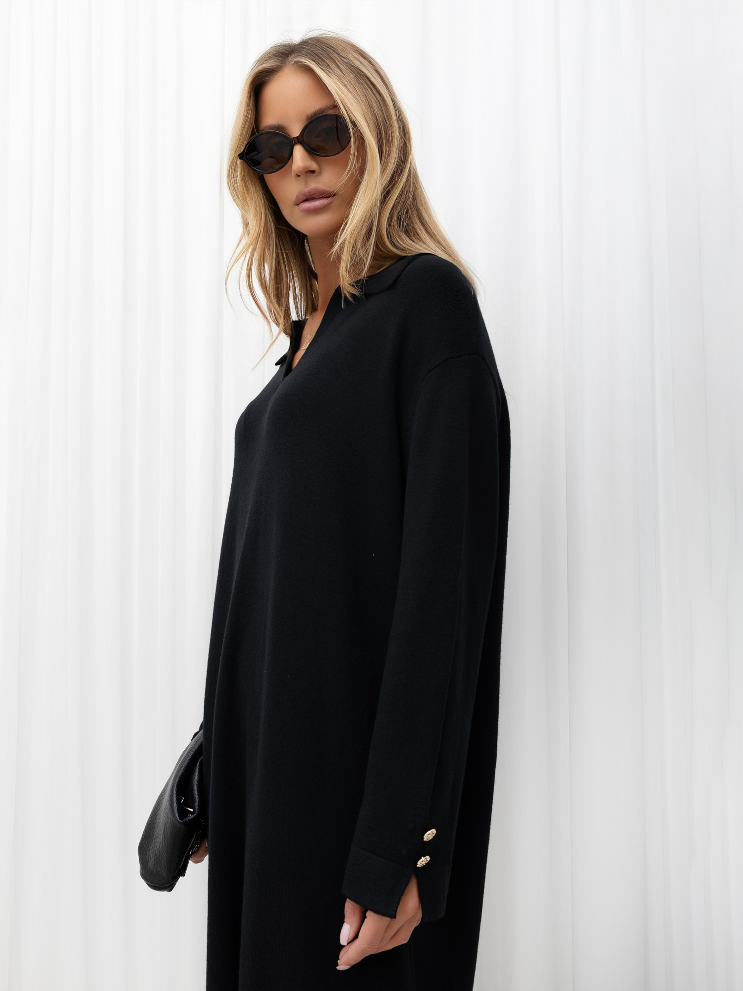 Black oversized knitted dress with a collar.