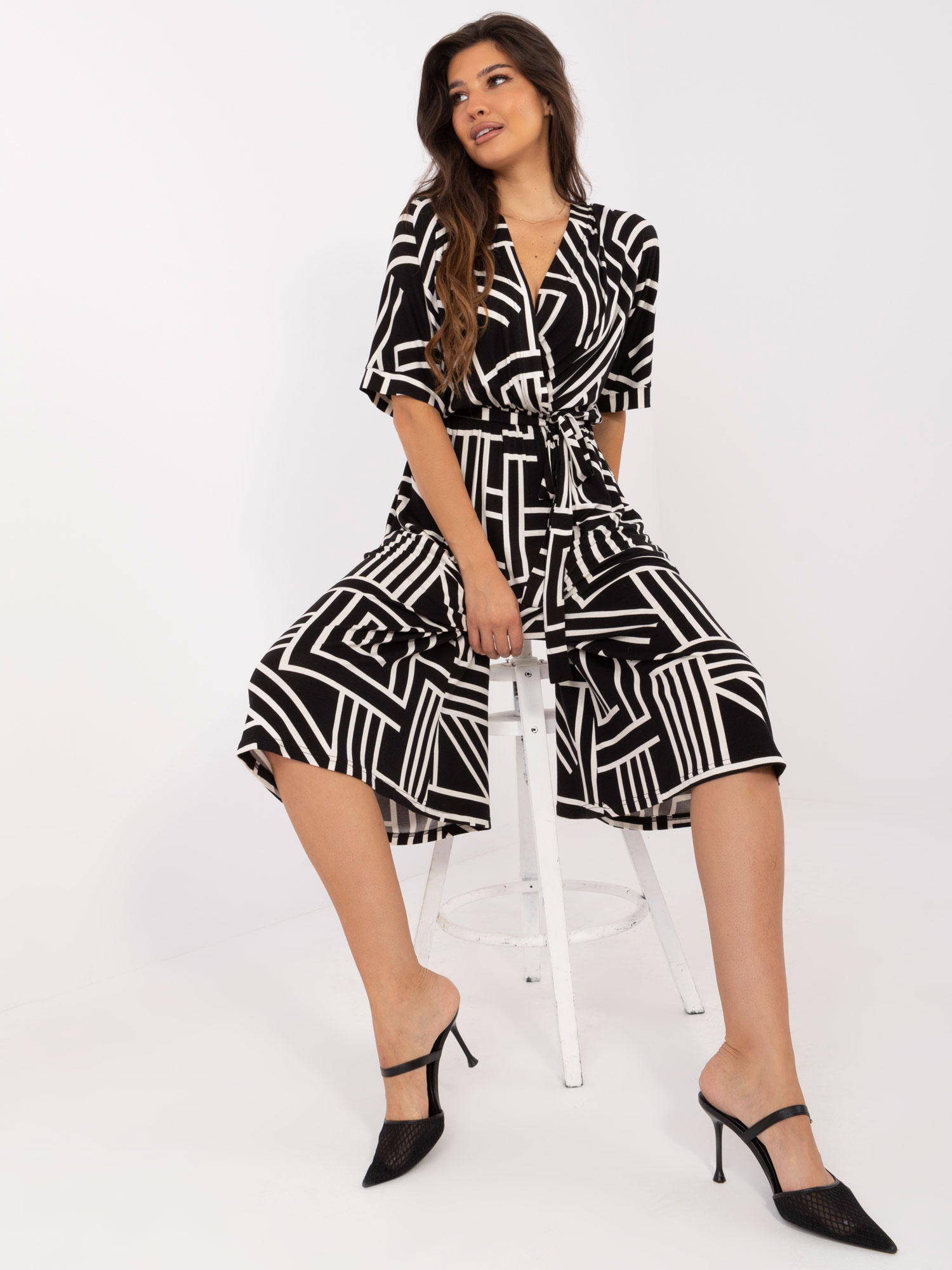 Hurt black patterned jumpsuit with a tie on the back.