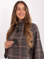 Light beige and black coat with large buttons.