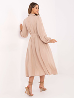 Beige shirt dress with a belt.