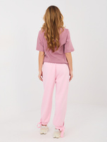 Jasnoróżowe dresowe spodnie z kokardkami