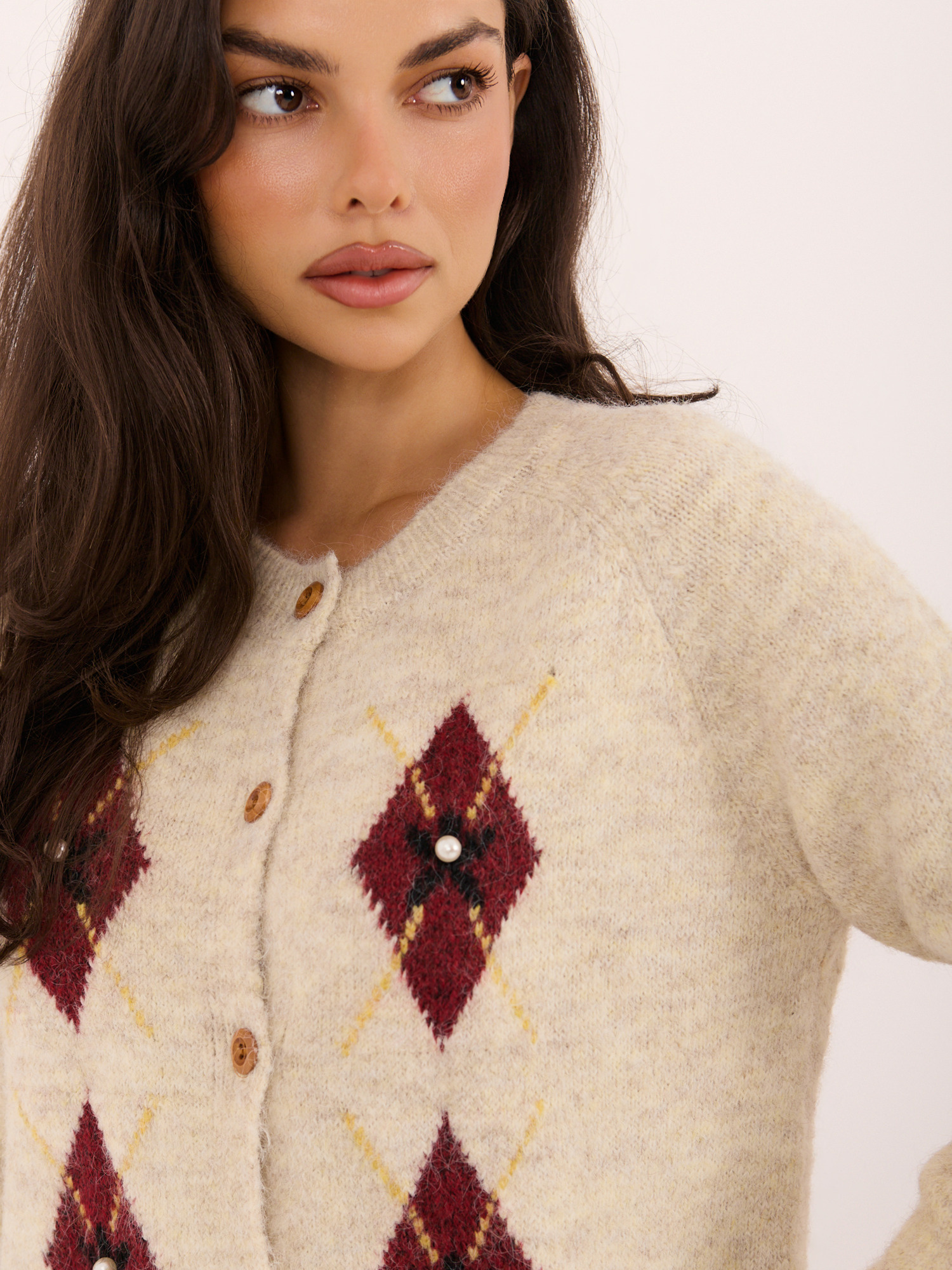 Light beige women's cardigan with pearls.