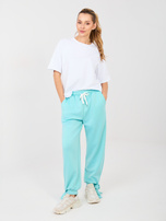 Miętowe dresowe spodnie z kieszeniami