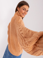 Hurt Peach oversized sweater with braids.
