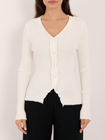 Ecru ribbed sweater with decorative buttons.