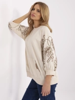 Helle beige Damen-Kapuzensweatshirt mit Stickerei.