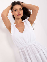 White muslin dress with straps.