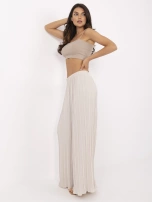 Beige wide trousers made of textured fabric.