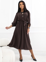 Brown shirt dress with decorative brooches.