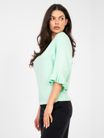 Pastelowy miętowy sweter z rozkloszowanym rękawem