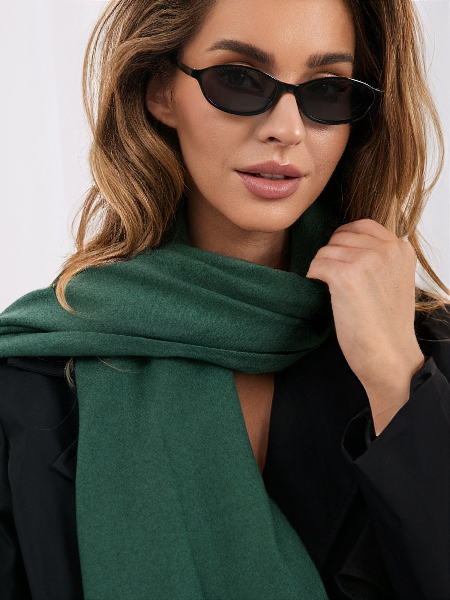 Dark green smooth scarf with fringes.