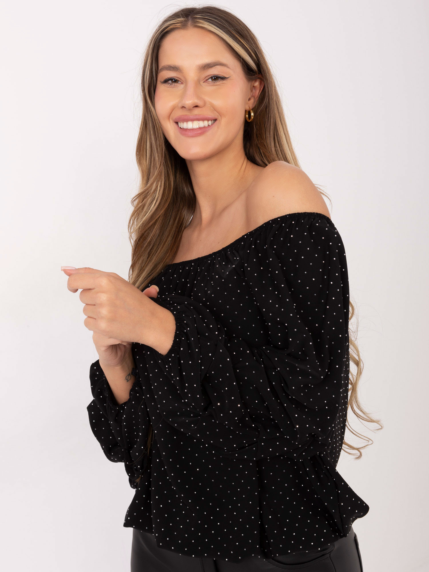Black off-the-shoulder blouse with gathered sleeves.