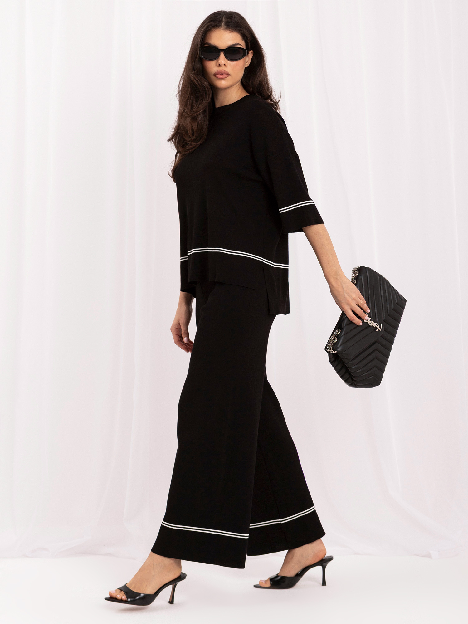 Black knit set with wide trousers.