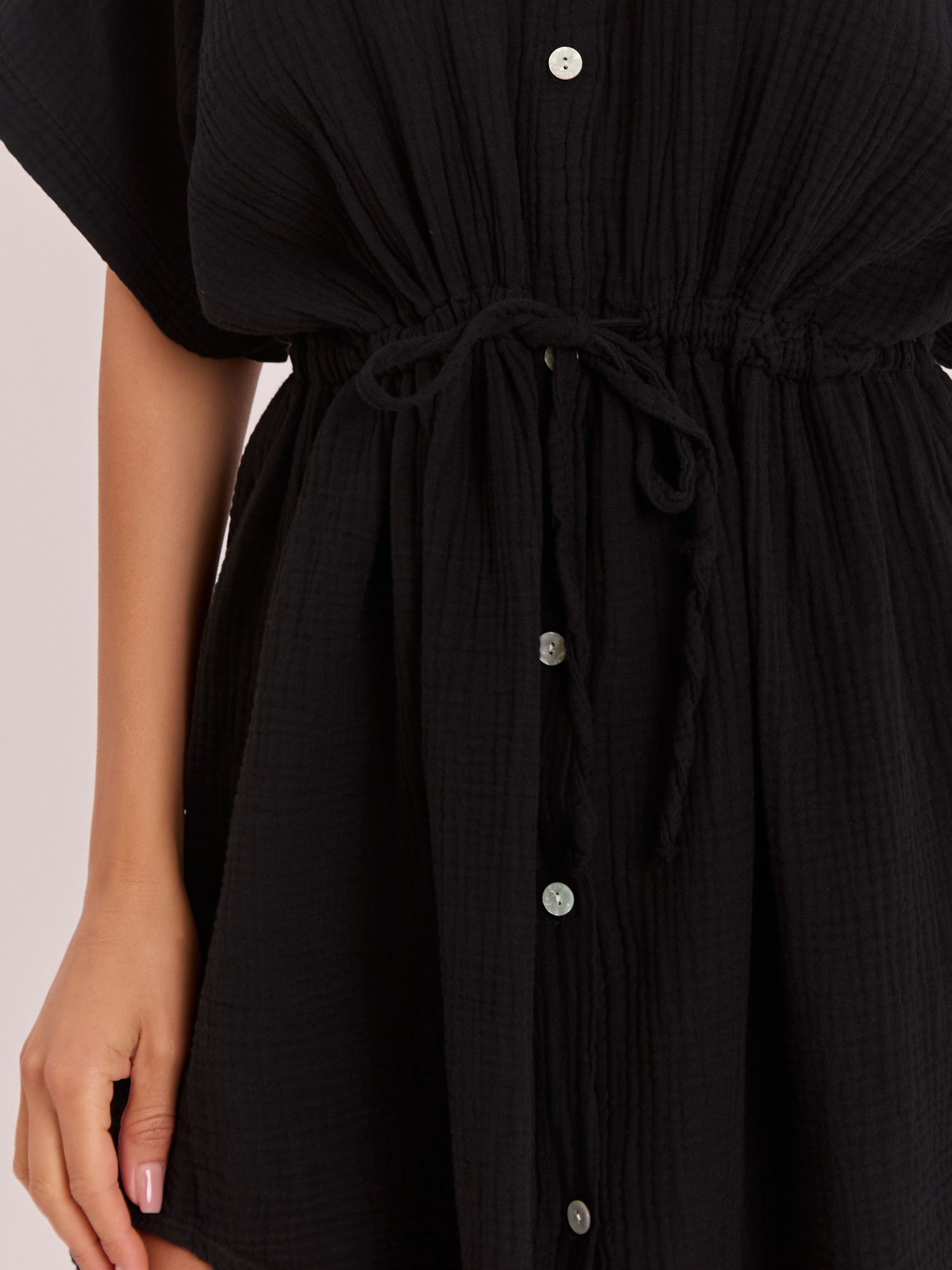 Black muslin dress with short sleeves.
