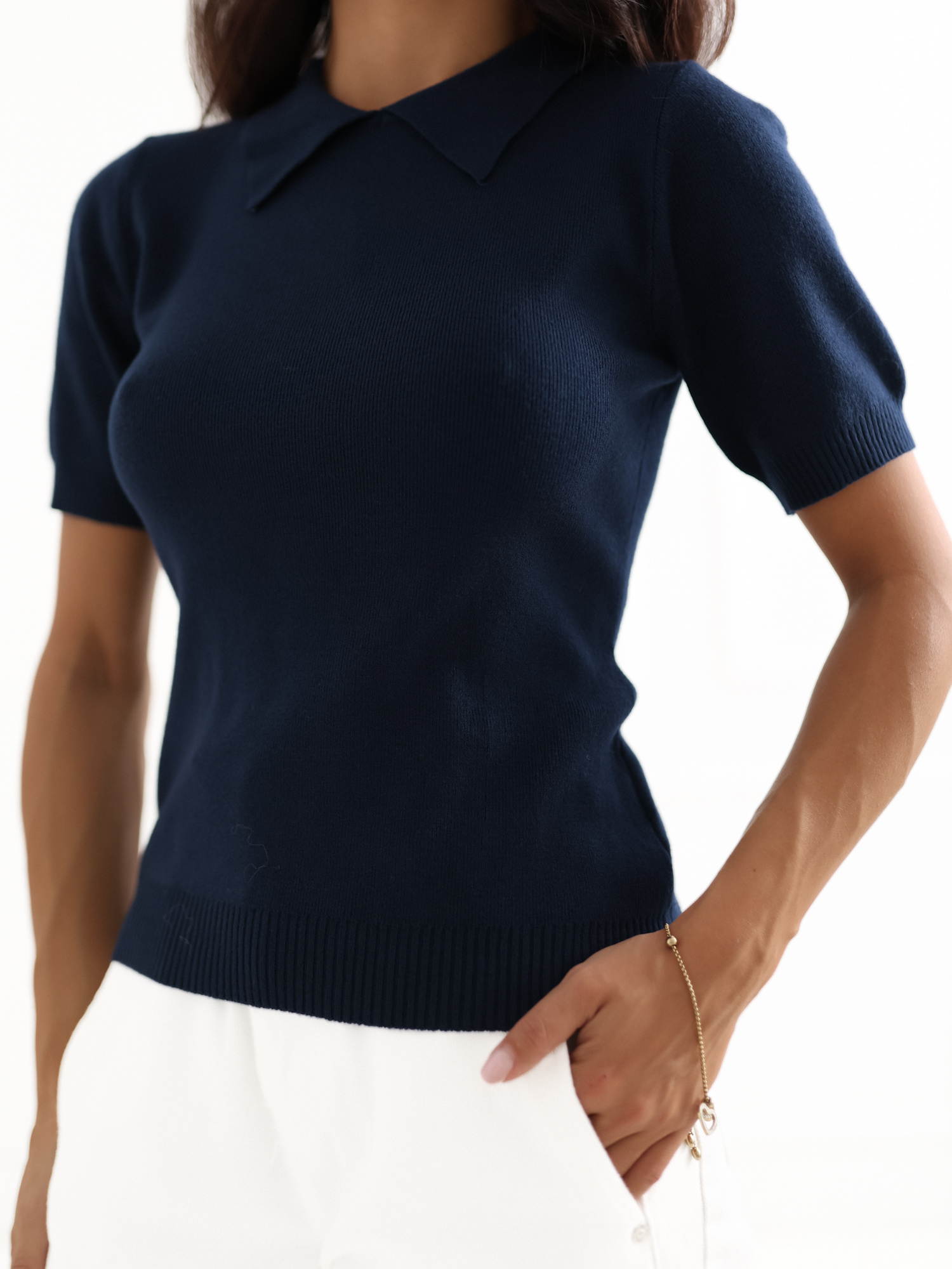 Navy blue women's polo sweater with short sleeves.