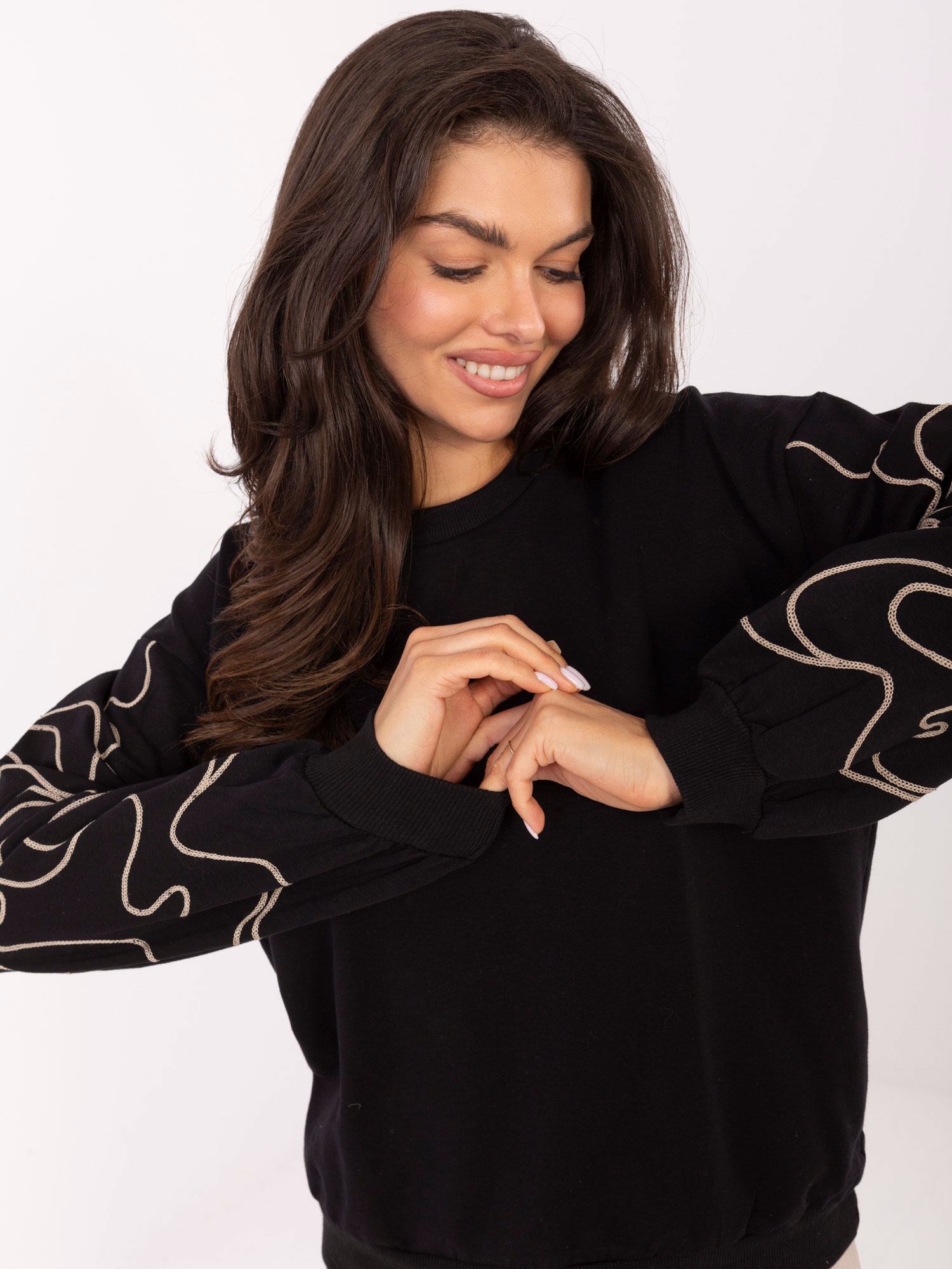 Black women's sweatshirt with embroidery on the sleeves.
