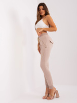 Hurt Beżowe damskie spodnie dresowe z aplikacją