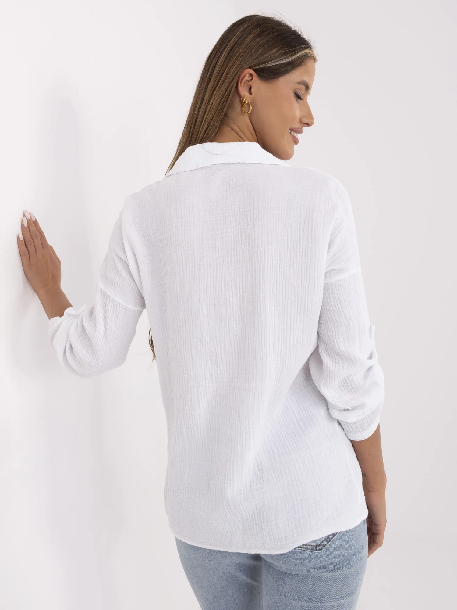 White women's button-up shirt made of muslin.